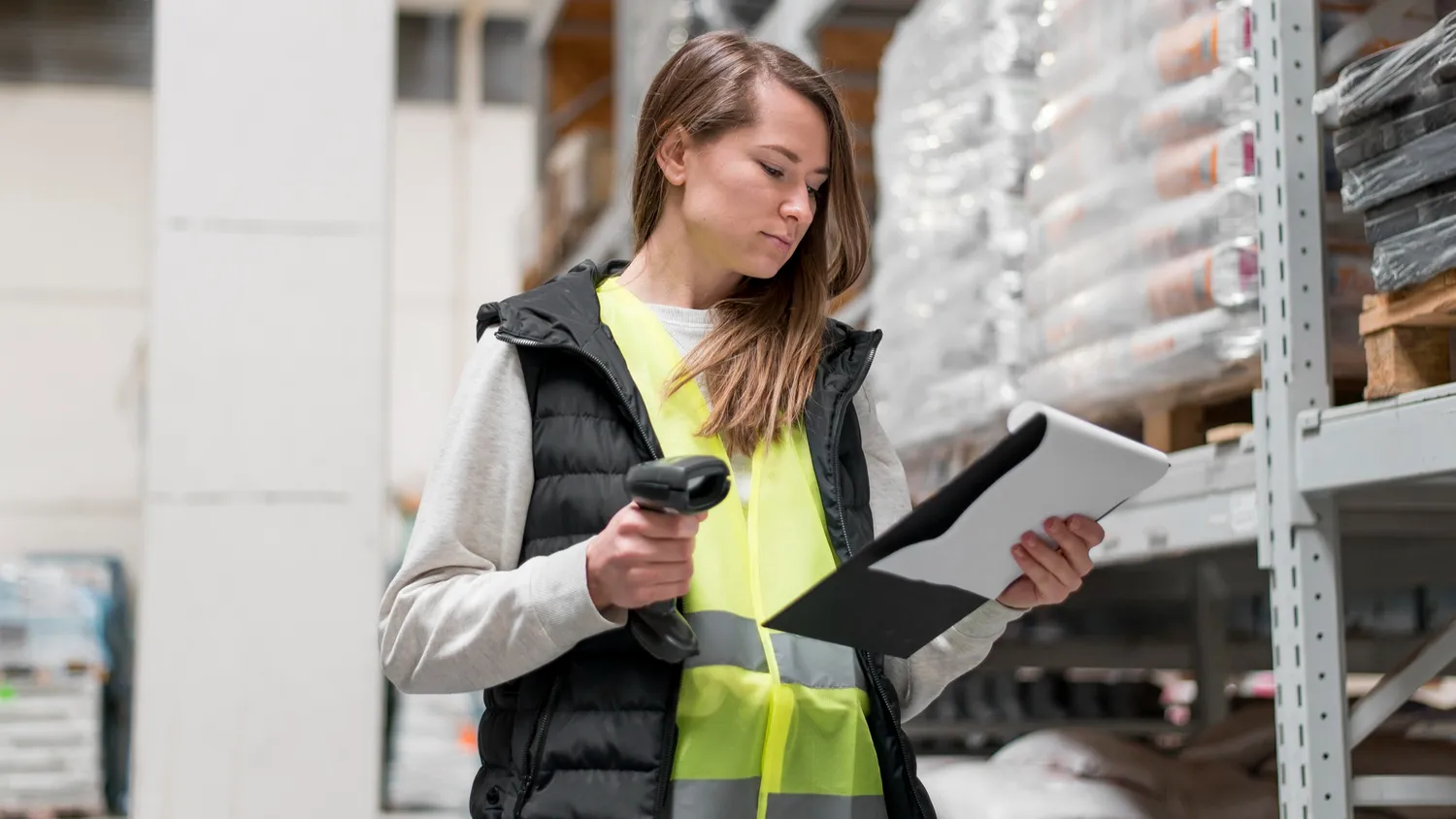 woman in warehouse with inventory management